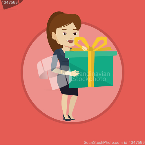 Image of Joyful caucasian woman holding box with gift.