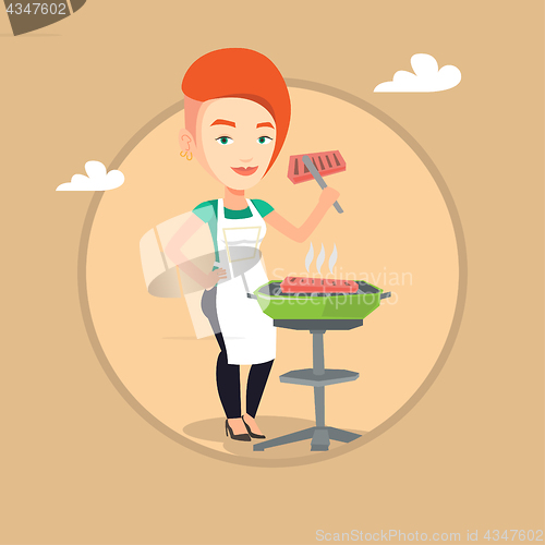 Image of Woman cooking steak on barbecue grill.