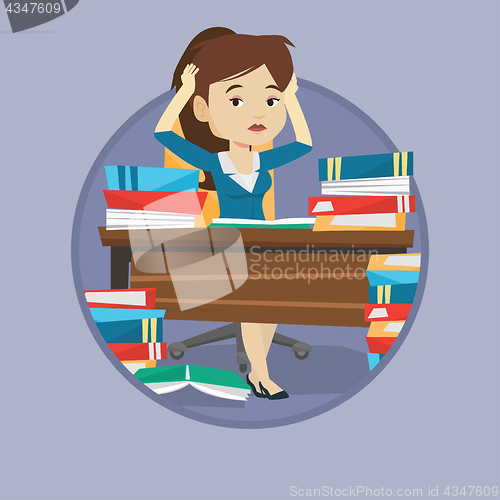 Image of Student sitting at the table with piles of books.