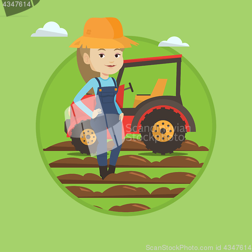 Image of Farmer standing with tractor on background.