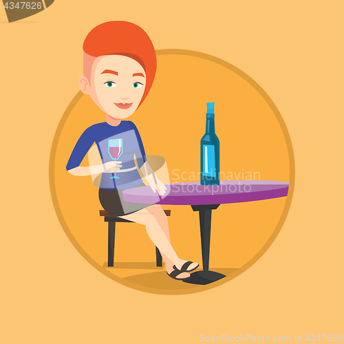 Image of Woman drinking wine at restaurant.