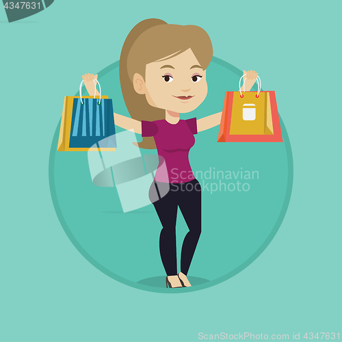 Image of Happy woman holding shopping bags.