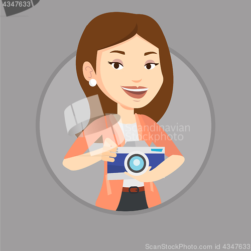 Image of Photographer with camera in photo studio.