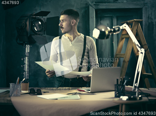 Image of Architect working on drawing table in office