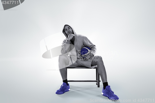 Image of Full length portrait of a basketball player with ball