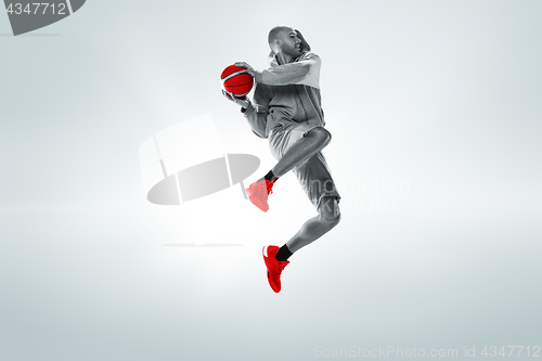 Image of Full length portrait of a basketball player with ball