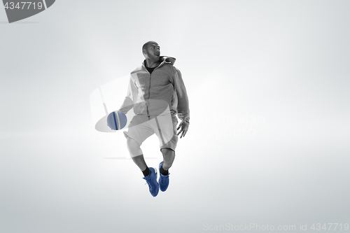 Image of Full length portrait of a basketball player with ball