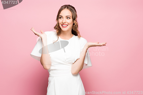 Image of Surprised happy beautiful woman looking sideways in excitement.