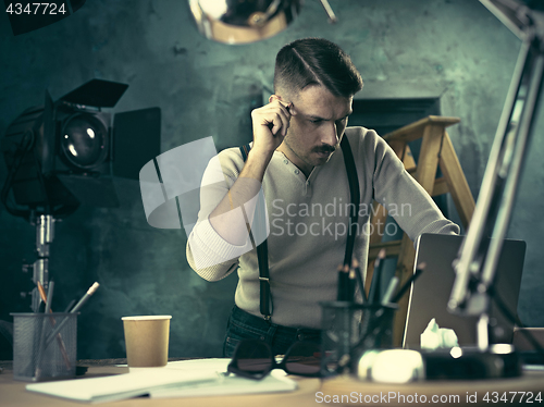 Image of Architect working on drawing table in office