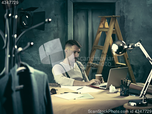 Image of Architect working on drawing table in office