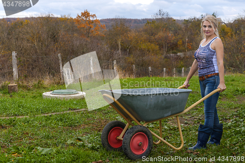 Image of Blonde with a wheelbarrow