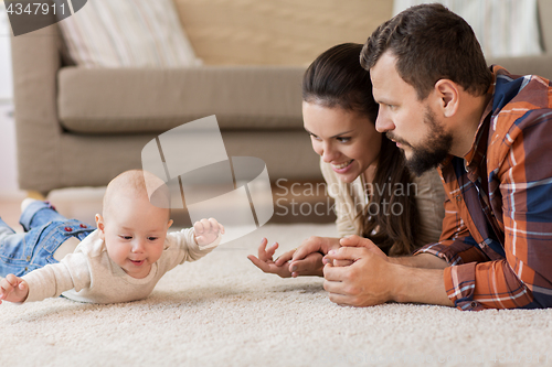 Image of happy family playing with baby at home