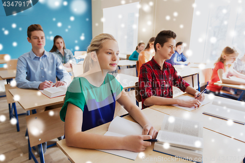 Image of group of students with books at school lesson