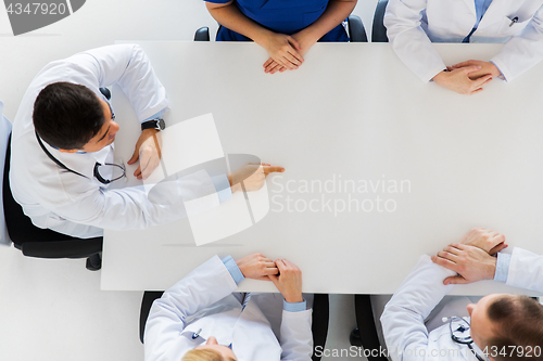Image of doctor showing something imaginary on table