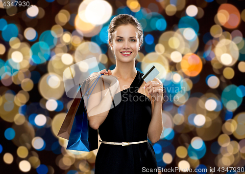 Image of woman with credit card and shopping bags