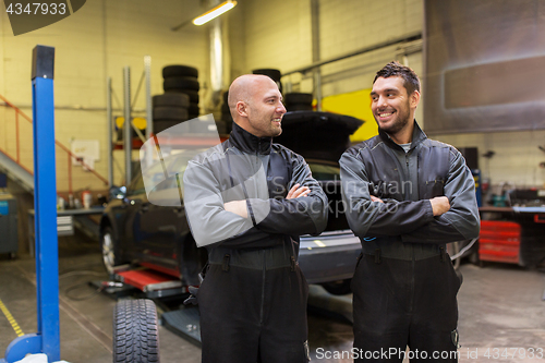 Image of auto mechanics or tire changers at car shop