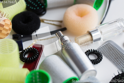 Image of hair styling sprays, curlers and scrunchies