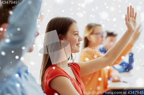 Image of student girl raising hand at school lesson