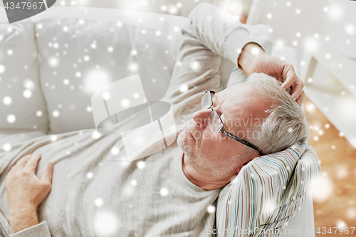 Image of close up of senior man in glasses thinking at home