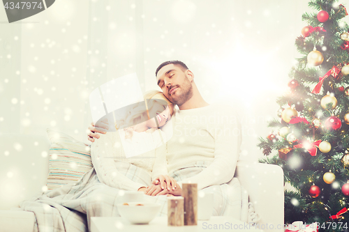 Image of happy couple at home with christmas tree