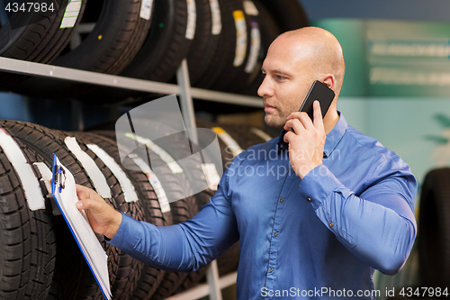 Image of auto business owner ordering tires at car service