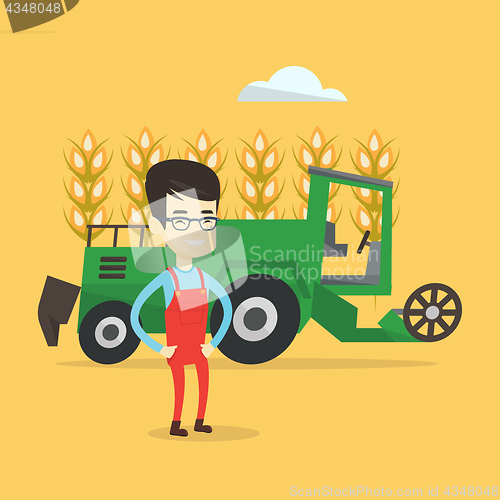 Image of Farmer standing with combine on background.