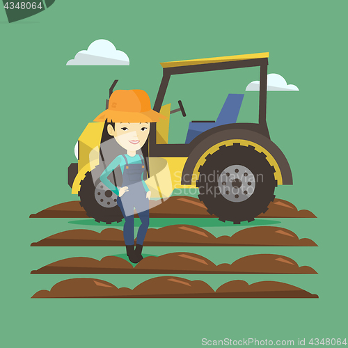 Image of Farmer standing with tractor on background.