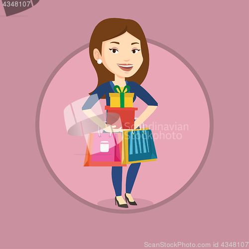 Image of Happy woman holding shopping bags and gift boxes.