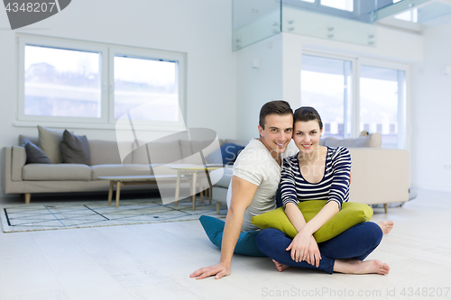 Image of couple sitting on the floor at home