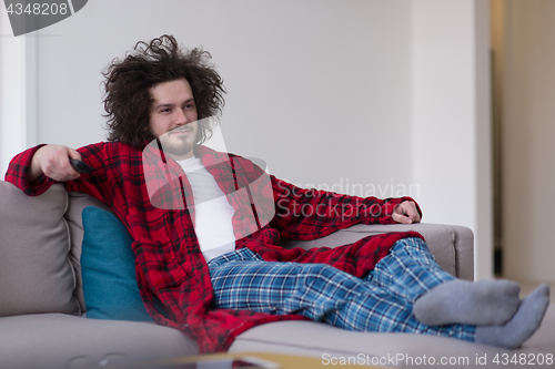 Image of young man in bathrobe enjoying free time