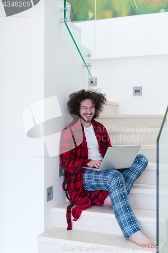 Image of freelancer in bathrobe working from home