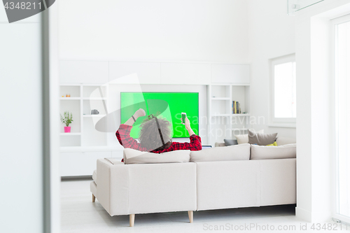 Image of young man in bathrobe enjoying free time