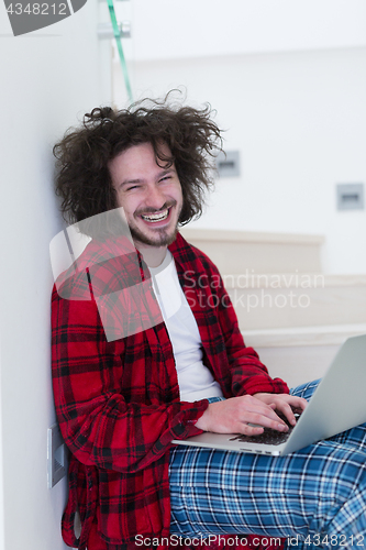 Image of freelancer in bathrobe working from home