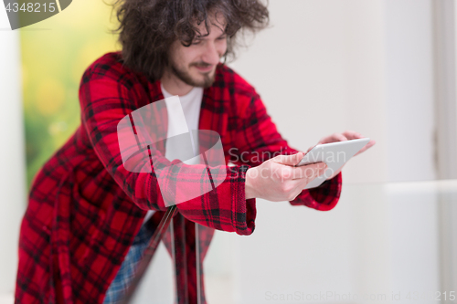 Image of young freelancer using tablet computer