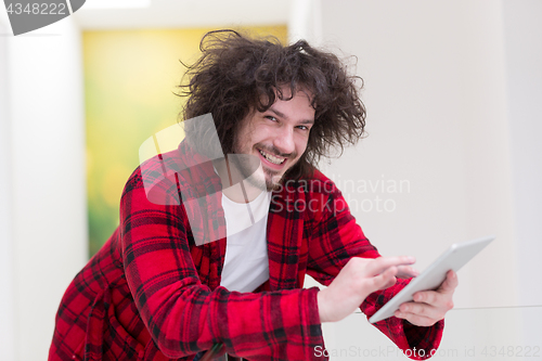 Image of young freelancer using tablet computer