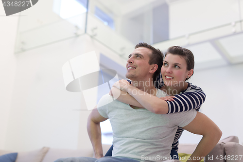 Image of handsome man piggybacking his girlfriend