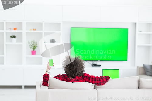 Image of young man in bathrobe enjoying free time