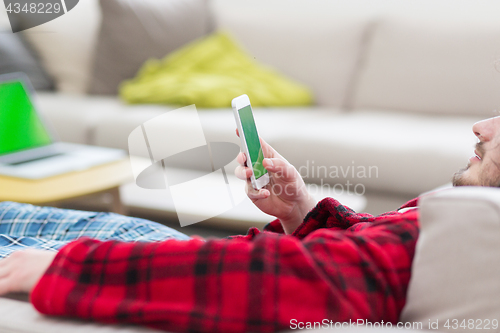 Image of young man in bathrobe enjoying free time