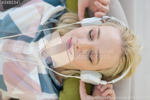 Image of girl enjoying music through headphones