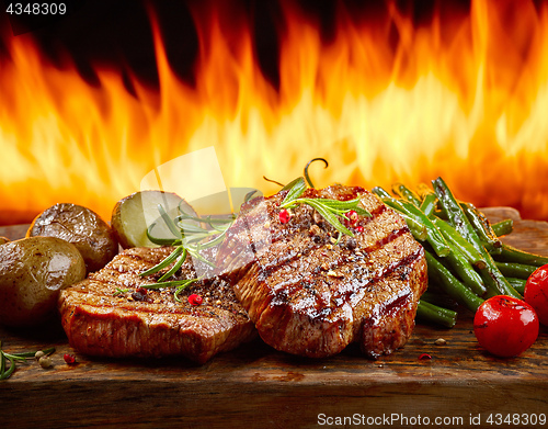 Image of freshly grilled steaks and vegetables