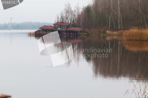 Image of Sinking boat station building on a Yanov backwater in Pripyat city, Chernobyl Exclusion Zone, Ukraine