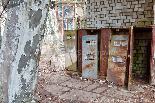 Image of Broken refreshments drinks machines in overgrown ghost city Pripyat.