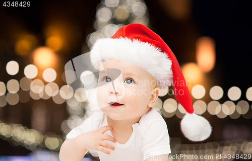 Image of little baby boy in santa hat at christmas