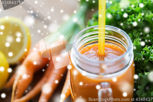 Image of close up of glass jug or mug with carrot juice