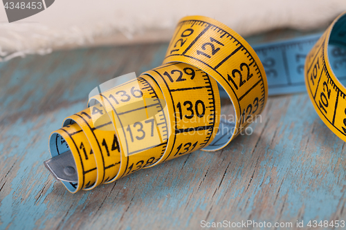 Image of Retro sewing accessories on blue wooden background