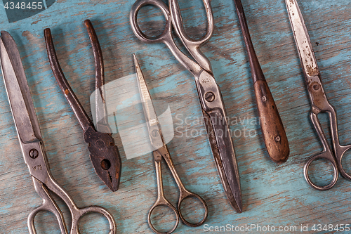 Image of Collection of vintage tools on a blue wooden background