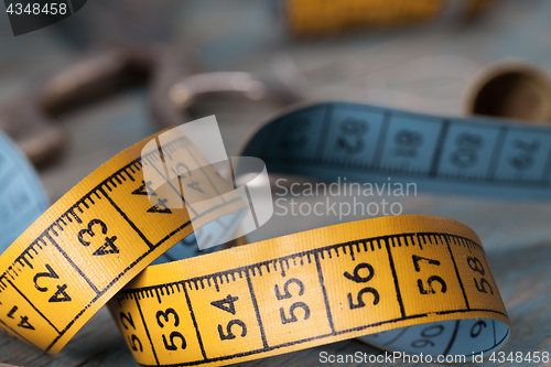 Image of Retro sewing accessories on blue wooden background