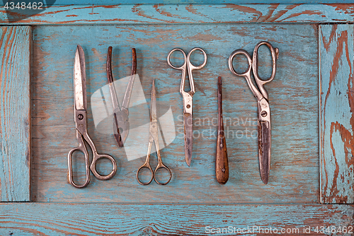 Image of Collection of vintage tools on a blue wooden background