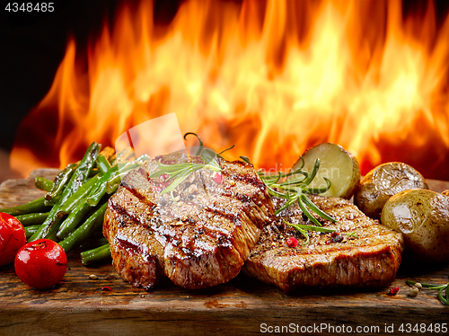 Image of freshly grilled steaks and vegetables