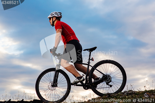 Image of Man in helmet and glasses stay on the bicycle